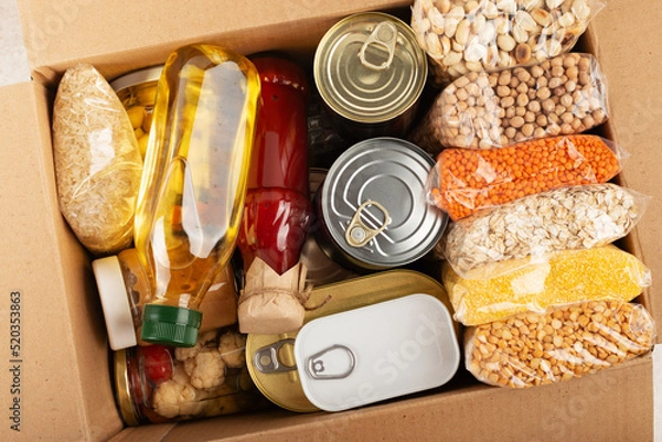 Fototapeta Survival set of nonperishable foods in carton box