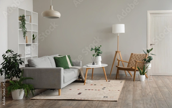 Obraz Interior of light living room with grey sofa, table and armchair
