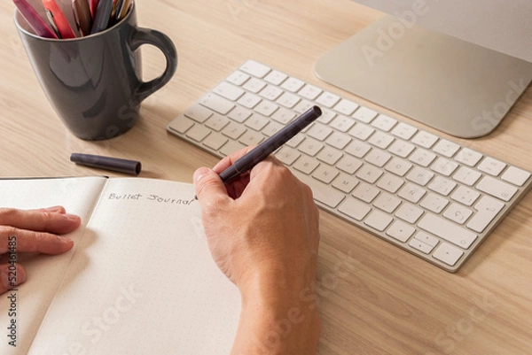 Obraz Man's hands writing in a notebook