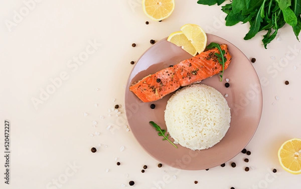 Obraz Baked salmon with spices and rice. Top view