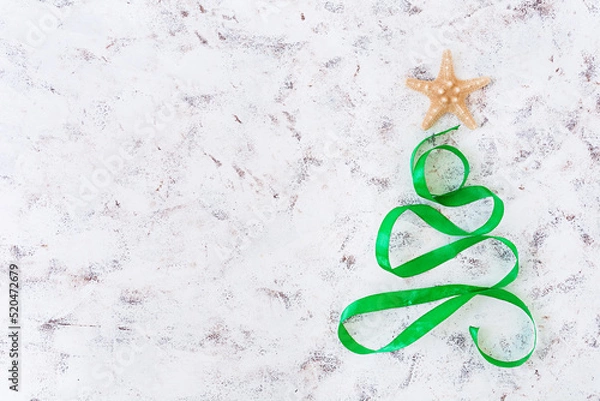 Obraz Christmas tree made of ribbon and starfish on white background. Top view