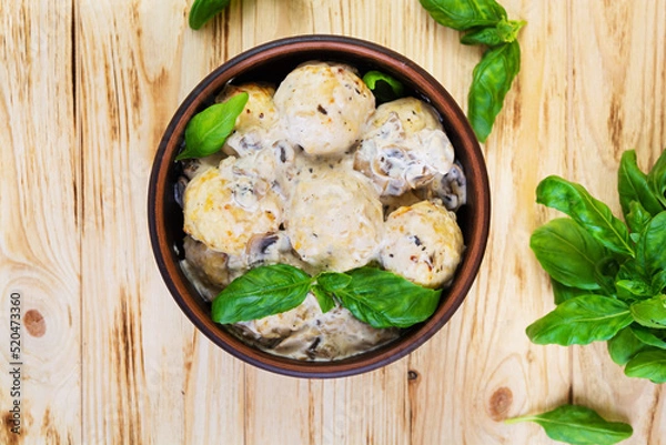 Obraz Meatballs with cream and mushrooms on wooden background