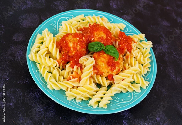 Obraz Meatballs with fusilli on dark background.