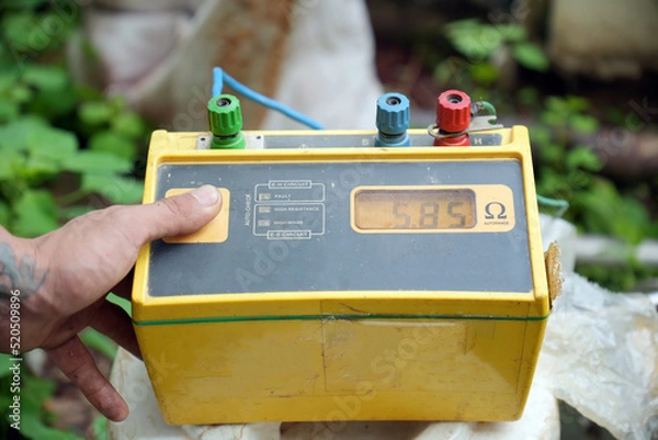 Fototapeta Technician using the old equipment and Earth resistance tester.