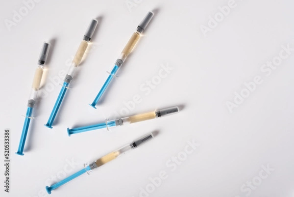 Obraz Five syringes with medicine for injection lie on a white background