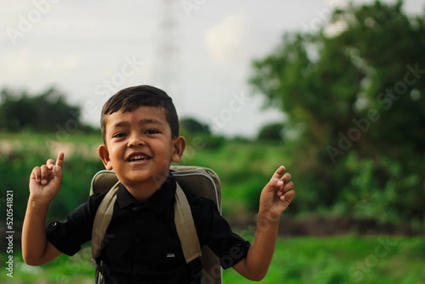 Obraz A student boy outside at school standing and smiling,