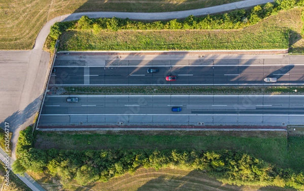 Fototapeta German highway coming out of tunnel seen from above near Munich with car traffic