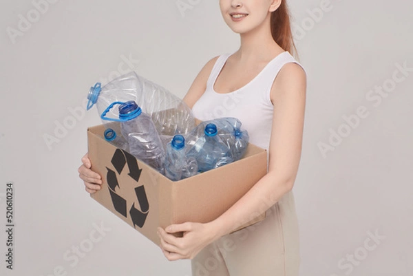 Fototapeta girl hold a box for recycling, she hold in hands box with plastic, eco concept, girl on the white background