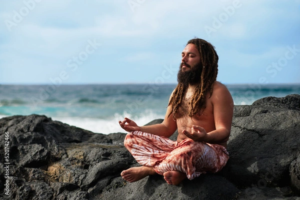 Obraz bearded rasta boy meditating by the sea