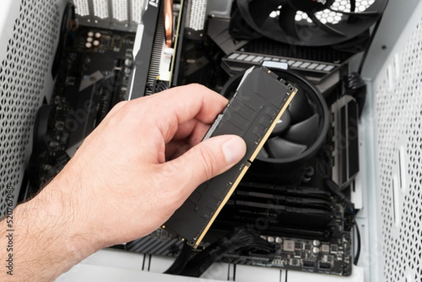 Obraz Hands of computer engineer instaliing RAM into modern desktop computer. Technology concept.