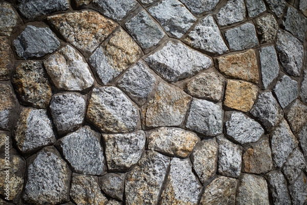 Fototapeta Background texture of Rough stone wall, Stone cladding, Old castle stone wall, Grey, brown Color, Close up shot