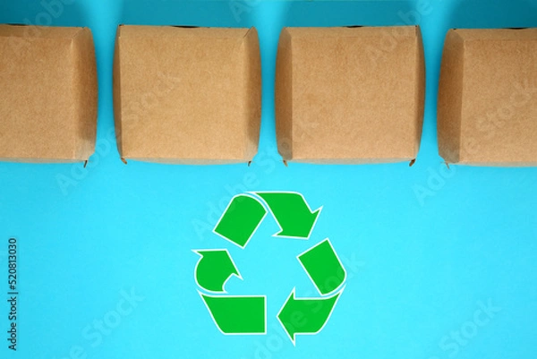 Obraz Paper boxes and recycling symbol on turquoise background, flat lay