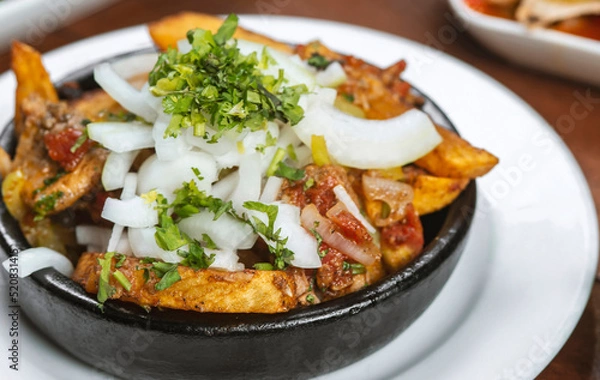 Fototapeta Beef stew with potatoes, carrots and herbs on black background with copy