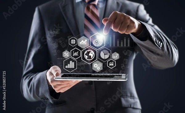 Fototapeta Businessman holding tablet with growing virtual hologram of statistics, graph and chart. Business strategy development and growing growth plan. Investment of growth on currency rate.