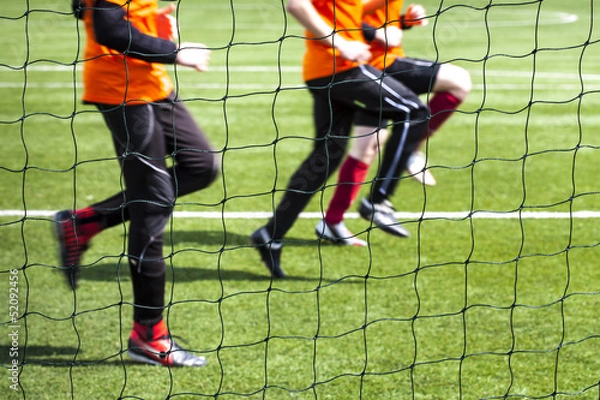 Obraz Training of soccer players seen by the grid.