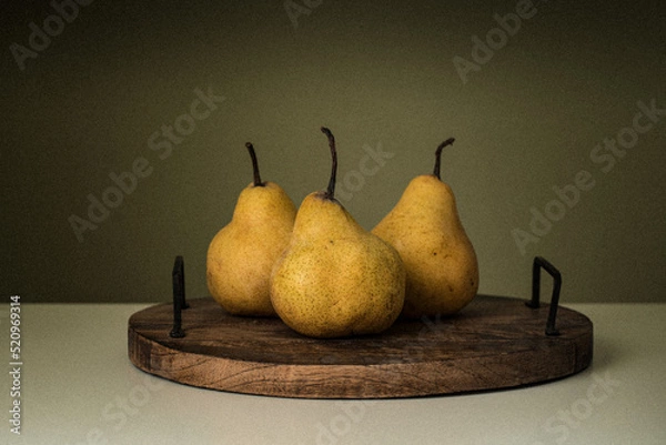 Obraz Still life of three pears on a wooden stand