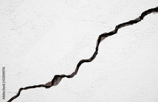 Fototapeta Long deep crack on the damaged wall as texture or background