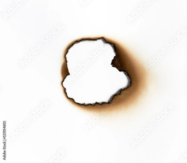 Obraz burned hole on a white paper background