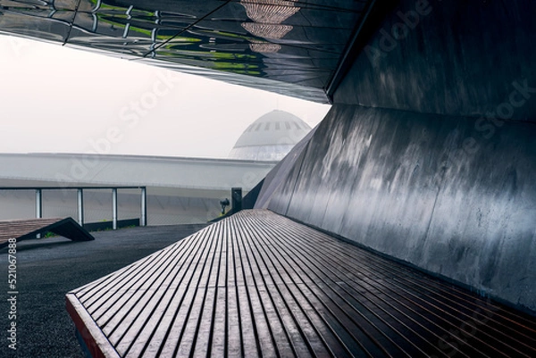 Fototapeta Katowice, Poland - 14 October 2021: View of the skylight of the sports and entertainment hall in Katowice. A wooden bench in the foreground