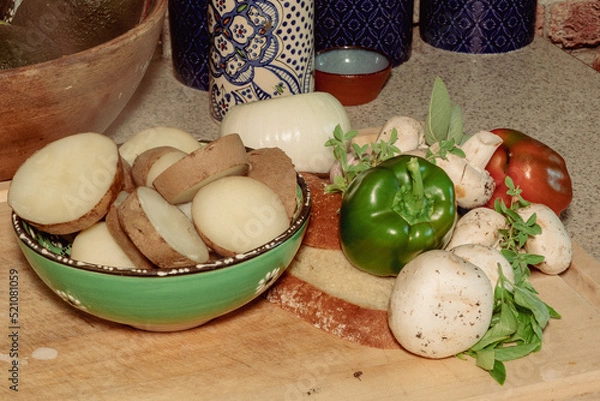 Obraz Steaming Potatoes, vegetables on a cutting board