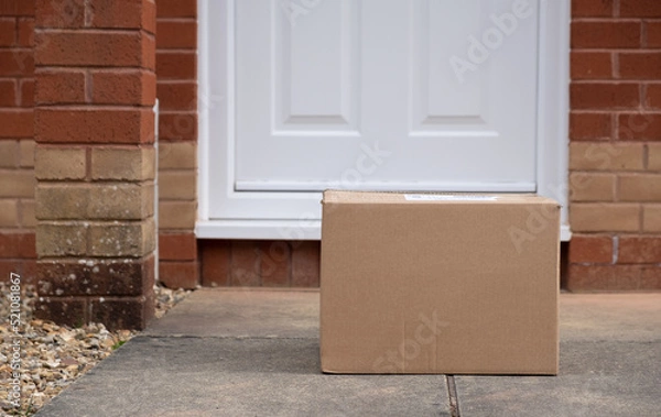 Obraz A large cardboard delivery box in front of a doorstep in the UK