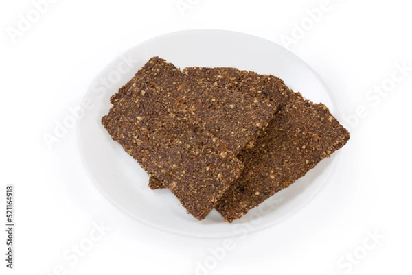 Obraz Flat crispbreads with vegetables and seeds on a saucer