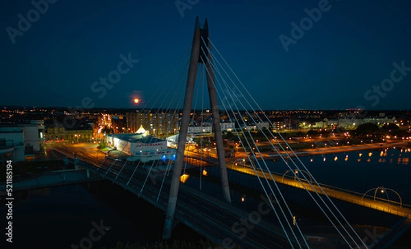 Fototapeta Aerial view of the Millennium Bridge at night with a full moon backdrop in Southport Merseyside