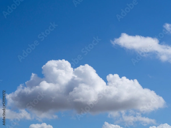 Fototapeta Clouds on a clear blue sky background. A cloud on a blue sky background