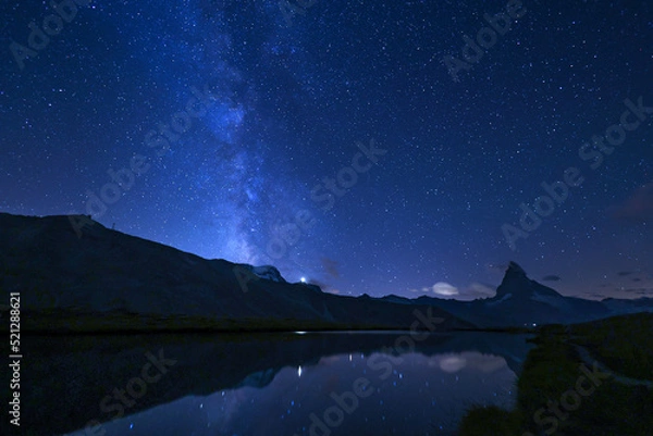 Obraz Matterhorn and the milkyway with reflection on the Stellisee lake at summer midnight, Zermatt, Switzerland