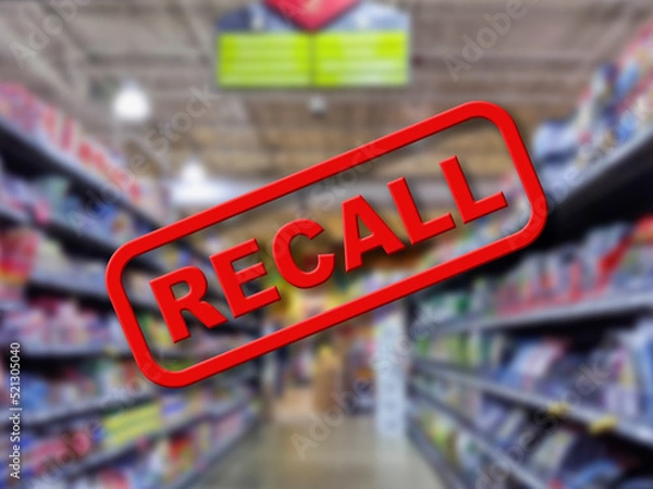 Fototapeta Blurry interior of a grocery store aisle behind large red Recall text