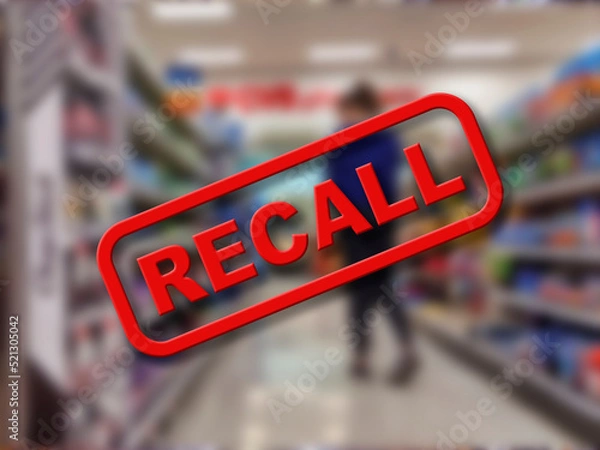 Fototapeta Blurry interior of a grocery store aisle behind large red Recall text