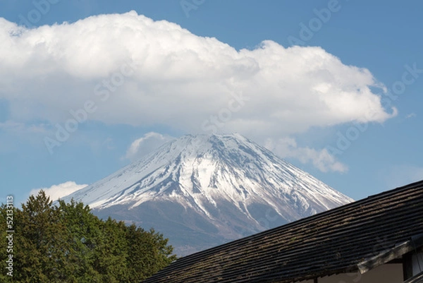 Fototapeta The peak of Mount Fuji on a cloudy day