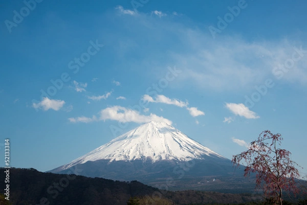 Fototapeta The peak of Mount Fuji on a cloudy day