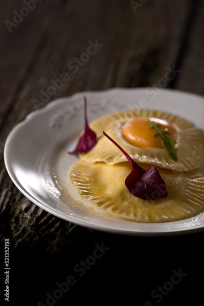 Fototapeta Dumpling with egg, on a dark background, food photography.