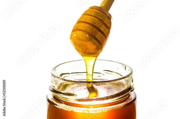 Fototapeta Honey on dipper from a jar
