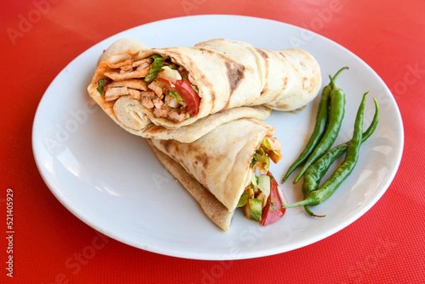 Fototapeta Lavash doner kebab ( doner zurna durum )  or shawarma sliced in plate isolated. 