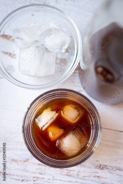 Fototapeta Top view of a glass cup with cold brew coffee on ice