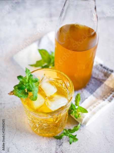 Obraz Iced tea with mint leaves on a white table