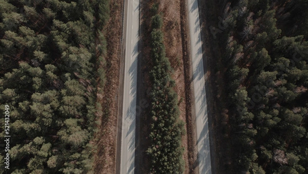 Fototapeta Highway road between deep forest in Ural