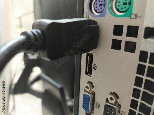 Obraz View of the rear of a PC computer, attached cables. Using DisplayPort for a PC Monitor. Blurred background