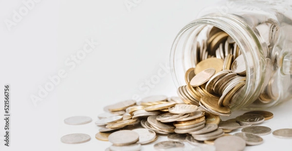Fototapeta Large quantity of  Thai baht coins in glass jar,color toned in clean pastel. Saving money concept.