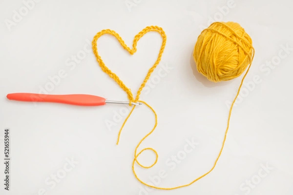Obraz Close up of a wool ball and heart shape on white background. Heart shaped woolen yarn. Love Crochet.
