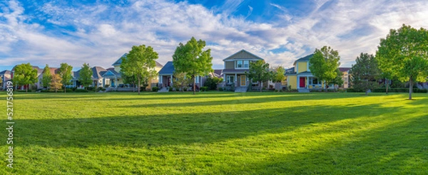 Fototapeta Residential area at Daybreak, Utah with large green fied at the front