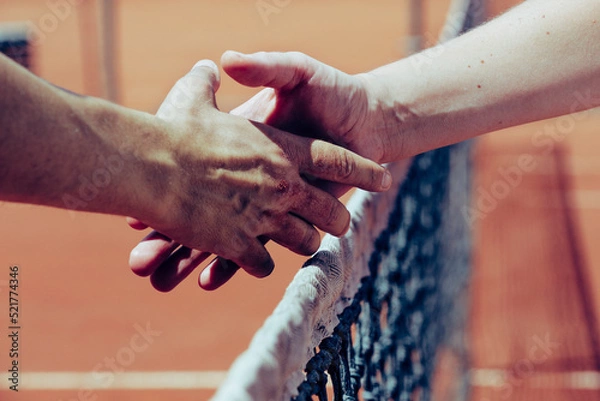 Fototapeta handshake between two people on the background of the sky