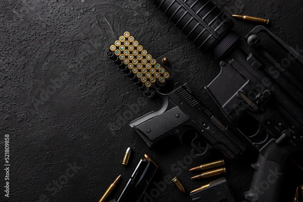 Fototapeta Gun with ammunition on table background. 