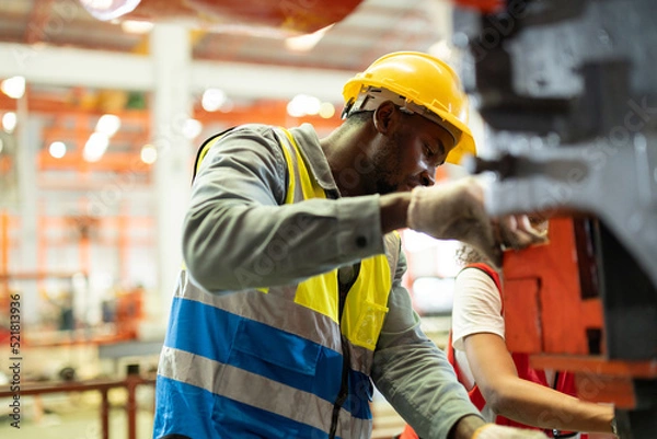 Obraz Close up hand industrial industrial plant, Engineer looking of working at industrial machinery setup in factory.
