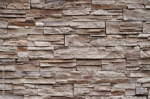 Fototapeta Colorful relief tiles imitating stone on wall close