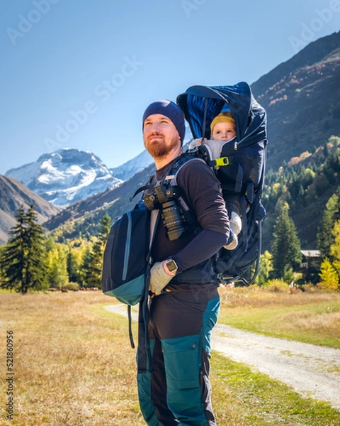 Obraz Father on a hiking trip with the 8 months old baby in a baby carrier