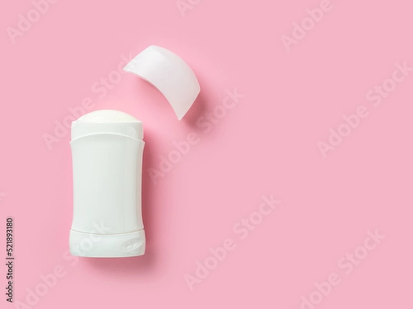 Obraz Solid antiperspirant over pink background with copy space. Open white plastic tube of body deodorant close-up. Toiletries for reduce perspiration, hygiene and body care concepts.