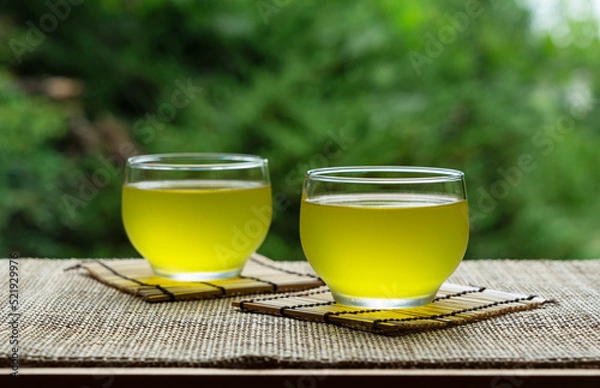 Fototapeta Cold Japanese green tea placed in a place with a view of the garden.